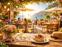 Затишне приморське кафе на заході сонця з келихами вина, десертом